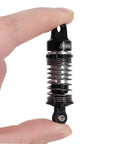 59mm Aluminum Oil Shocks With Adjustable Damping For Mojave Typhon Granite GROM RC Cars held between fingers close-up