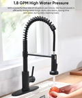 Heavy Duty Matte Black Kitchen Faucet With Smooth Operator Pull Down Sprayer And High Arc Spring Mount in action rinsing vegetables.