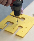 Close-up of Precision Routing Template For Seamless Drop Bolt Joint Connectors being drilled for installation on countertop.