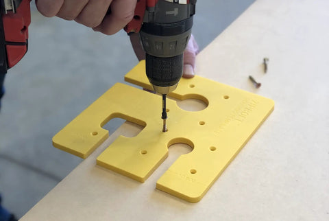 Close-up of Precision Routing Template For Seamless Drop Bolt Joint Connectors being drilled for installation on countertop.