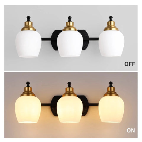Bold Black And Gold 3 Light Vanity Light Fixture With White Glass Globe shown off and on against wall