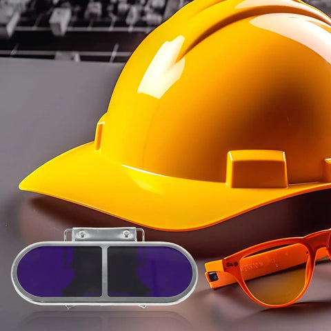Tough As Nails Metal Welding Goggles With Flip Up Lens And Secure Screw Clip For High Intensity Flame Shielding and hard hat on a workspace.