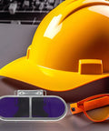 Rock Solid Welding Goggles With Clip Screw Mount, Hella Scratch Resistant Protective Eyewear For Steelmaking, Lock Tight Hat Clip, No Sweat Safety Glasses For Heavy Duty Industrial Jobs next to yellow hard hat.