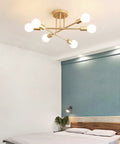 Cool Modern Sputnik Ceiling Chandelier, 6 Light LED Fixture With Included Bulbs, Gold Finish installed above a bedroom bed.