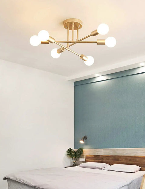 Cool Modern Sputnik Ceiling Chandelier, 6 Light LED Fixture With Included Bulbs, Gold Finish installed above a bedroom bed.