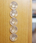 Sound Dampening Door Bumpers Half Inch Dia 5mm Height Soft Durometer installed on wood surface