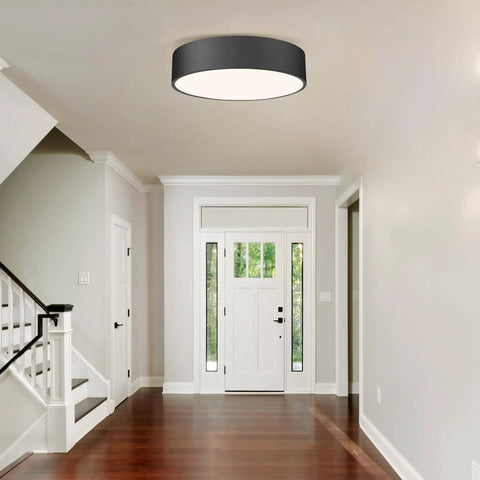 Two Light Flush Mount Ceiling Light With Slick Matte Black Frame And White Acrylic Shade in a modern hallway.