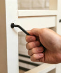 Hand using hex wrench to tighten Black Socket Cap Screws And Barrel Nuts Set For Bunk Beds Cribs And Furniture Repair