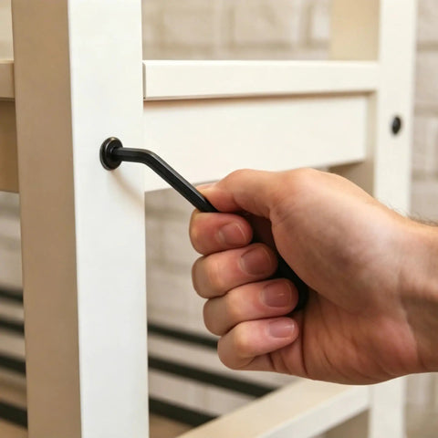 Hand using hex wrench to tighten Black Socket Cap Screws And Barrel Nuts Set For Bunk Beds Cribs And Furniture Repair