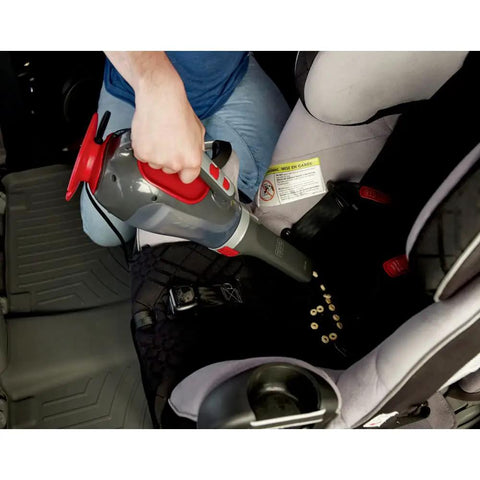 Using Dustbuster 12V Car Handheld Vacuum with Extra Long Nozzle to clean crumbs between car seats.