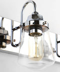 Close-up of Chrome Vanity Light Fixture for Bathroom Three Light Farmhouse Style Over Mirror with Clear Glass Shades