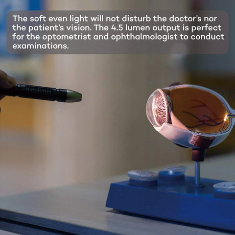 NoGlare Diagnostic Medical Pen Light With Pocket Clip shown illuminating an eye model, highlighting its 3000K LED feature.