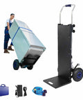 Heavy Duty Electric Stair Climbing Dolly With 1200 Watt Motor And Telescoping Handle For Hauling Up To 551 Lbs On Any Floor Or Stairs showing a worker using it to lift a large item.