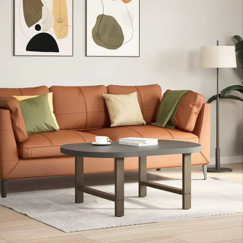 Modern living room with brown sofa, round gray table, and abstract artwork on wall.