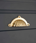 Polished Brass Cup Pull Cabinet Handle For Drawers And Doors, Cup Shell Design, fitted on dark gray cabinetry