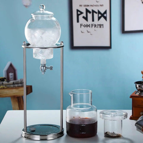 Smooth Chill Cold Brew Drip Tower Stainless Steel And Borosilicate Glass Coffee Maker on a countertop with ice and brewed coffee.