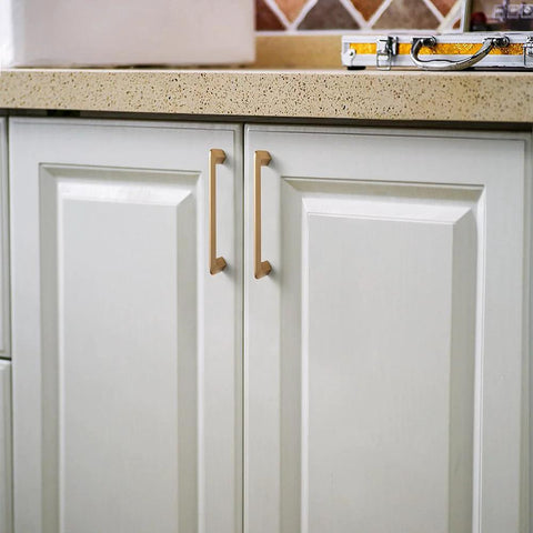 Champagne Bronze Zinc Alloy Cabinet Handles 5 Inch Center To Center 128mm installed on kitchen cabinets.