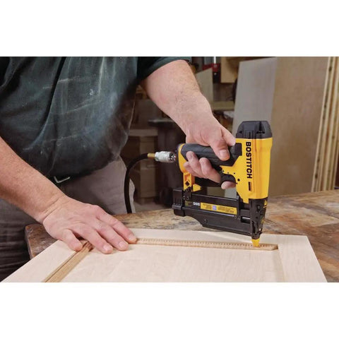 Person using 23 Gauge Pin Nailer 2 Inch Pneumatic Pinner With Tool Free Jam Release And Depth Adjustment Oil Free Operation on wood