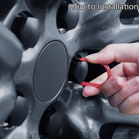 Hand using a dismantle tool to install Tesla Wheel Lug Nut Covers Kit For Model 3 Y S X, showing easy installation.