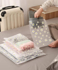 Stash And Pack Travel Storage Bags For Clothes And Gear Clear Reusable Ziplock Pouches Waterproof Resealable Luggage Organizer Set 5 Sizes 30 Pieces For Clothes Towels Shoes Cosmetics displayed on a bed.