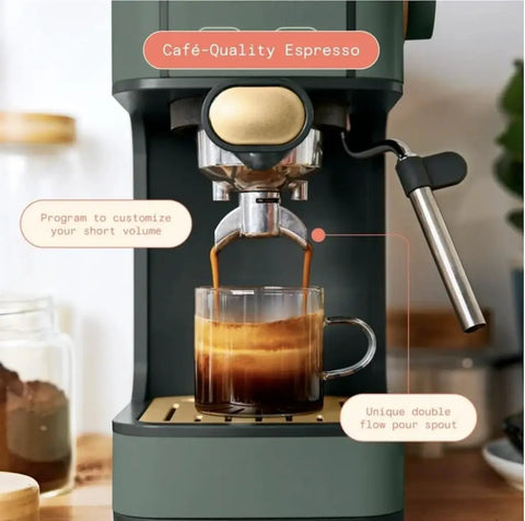 Rock Solid Compact Espresso Machine In Fresh Thyme Green delivering café-quality espresso into a glass coffee cup with crema.