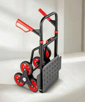Stair Climbing Hand Truck For Movers Portable Folding Cart Built With Sturdy Metal Frame Perforated Loading Base And Burgundy Handle Grips For Easy Stair Hauling And Heavy Lifting On The Job, black and red six-wheel cart