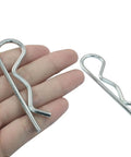 Close-up of 20 Piece Zinc Plated Cotter Pins Set M3.5 X 75mm, showing size against hand for DIY and trailer use.