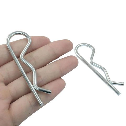 Close-up of 20 Piece Zinc Plated Cotter Pins Set M3.5 X 75mm, showing size against hand for DIY and trailer use.