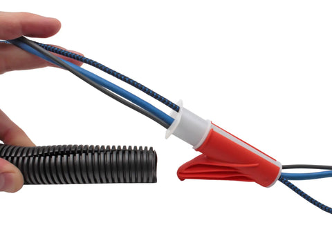 Wire Loom Insertion Tool Set For Three Eighths To Two Inch Conduit Sleeving, hand using red tool on black conduit