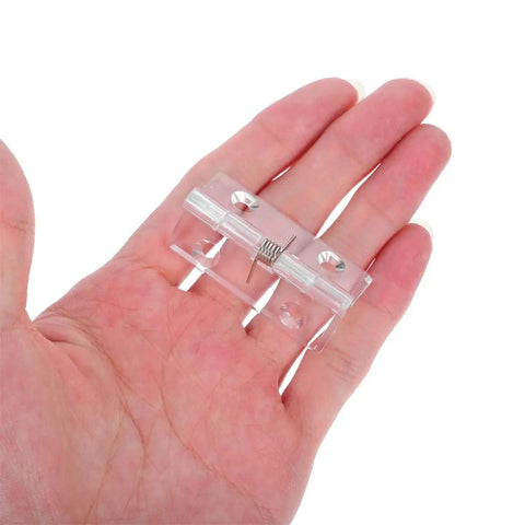 Hand holding Six Pack Acrylic Self Closing Concealed Door Hinges With Spring Mechanism 45x35mm Invisible Cabinet And Interior Door Hardware