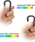 Hands holding black 2.28-inch carabiner clip with text "Improved Tight Spring," part of 2 Point 28 Inch Small Aluminum Carabiner Clips Set Of 20 D Ring Keychain Clips Multipurpose Snap Hooks For Belts Backpacks Lanyards Hiking Travel Gear And EDC Ready Everyday Use.
