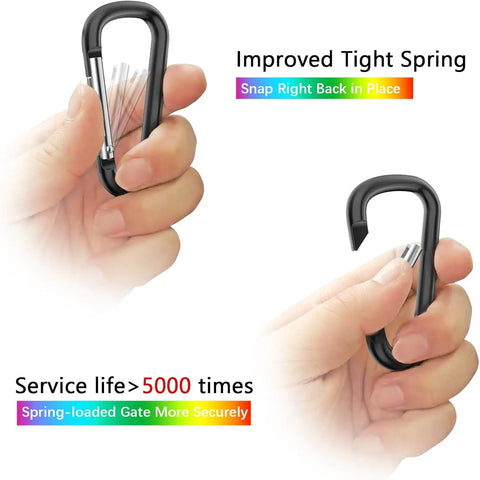 Hands holding black 2.28-inch carabiner clip with text "Improved Tight Spring," part of 2 Point 28 Inch Small Aluminum Carabiner Clips Set Of 20 D Ring Keychain Clips Multipurpose Snap Hooks For Belts Backpacks Lanyards Hiking Travel Gear And EDC Ready Everyday Use.