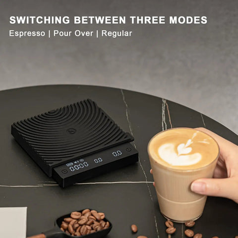 Ultra Slim Mini Coffee Scale With Timer For Espresso And Baking next to a cup of coffee on a black surface