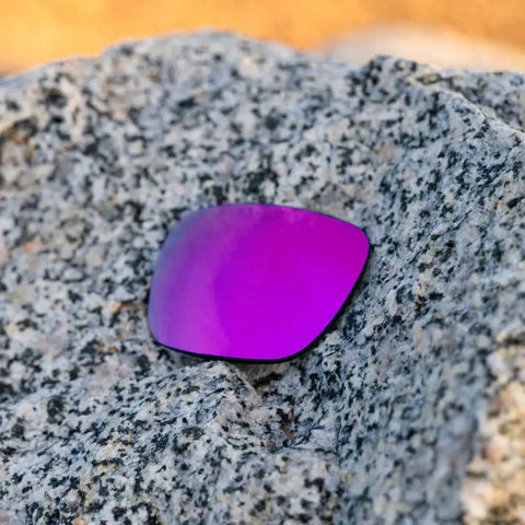 Apex Purple Non Polarized Replacement Lenses For Electric Stacker Sunglasses Made In Usa on a textured rock surface.