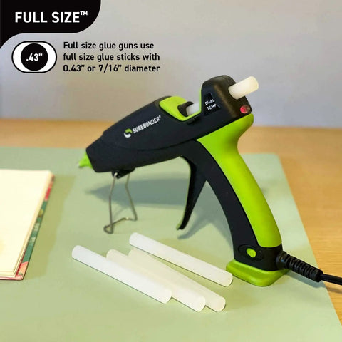 Dual Temp All Purpose Full Size Hot Glue Sticks For Crafts And DIY 0.43 By 4 Inches next to green-black glue gun on table