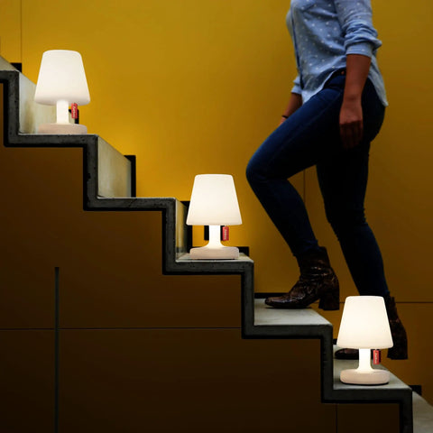Tiny Rechargeable LED Lamp 2.0 Go Anywhere Dimmable Table Light on stairs with person walking, ideal for indoor outdoor use