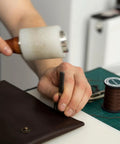 Person using Two Piece Leather Hole Punch Set With 0.5mm And 1mm Hollow Round Punches, Alloy Steel Construction on leather