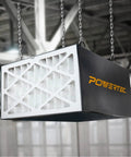 Hanging Powertec air filtration unit in workshop, showcasing filter section. Focus keyword not depicted.