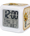 Slick Farmhouse Sunflower Bee Cube Digital Alarm Clock with temp gauge and nightlight on a white base displaying 12:00.
