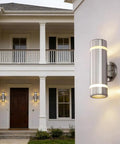 Dope Modern Cylinder Outdoor Wall Light Stainless Steel Porch Sconce With Nickel Finish, mounted on house entrance, glowing.