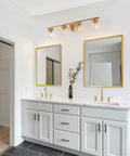 Gold Bathroom Vanity Light 28 Inch Four Light Fixture With Clear Glass Globes, Hand Painted Gold Finish, in a modern bathroom.