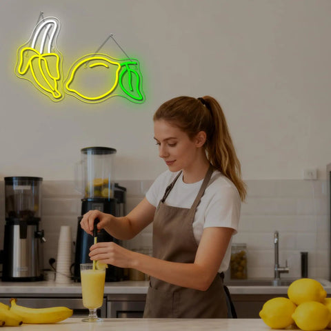 Woman making smoothie under Bright Dope Banana Shaped LED Neon Sign Light For Bedroom Decor, Kids Room Wall Art, Party Bar Glow, lemon art.