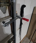 Pro Grade Vertical Toggle Clamp Featuring A Quick Release Lever And Unmatched 400 Lbs Holding Capacity For Rock Solid Workshop Clamping And No Sweat Assembly Jobs mounted on a door frame.
