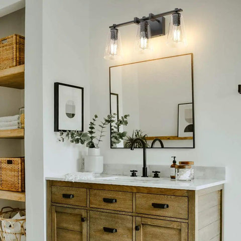 Vintage Industrial 3 Light Vanity Sconce In Black With Bubble Glass Shades above a wooden bathroom vanity.