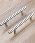 Stainless Steel Brushed Satin Nickel Cabinet Pulls Pack Of 30 Hollow Tube T Bar Drawer Handles on wooden surface