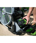 Person inserting battery into Go To Outdoor Mist Cooling Fan With 18 Inch Blade, 5 Speed Settings, Delivers Up To 5,000 CFM, Two Misting Modes.