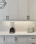 Matte Black Cabinet Hardware 10 Pack 3 Inch Hole Center Kitchen Handles on white cabinets above counter with blender and toaster.
