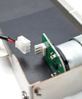 Close-up of DC 24V Stainless Steel Mini Conveyor Belt System for Vending Machines, showing motor and connector, 85mm track.