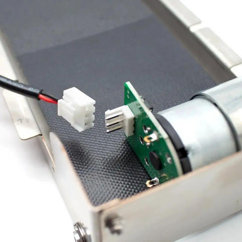 Close-up of DC 24V Stainless Steel Mini Conveyor Belt System for Vending Machines, showing motor and connector, 85mm track.