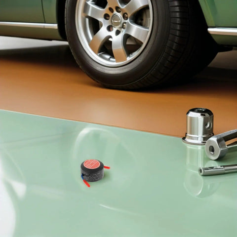 Compact Automatic Aerosol Fire Extinguisher Kit For Car Engines And Garages, two fire suppressors beside a car tire in a garage.